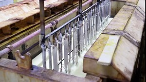 Immersion of metal plates in an electroplating bath. Tin-bismuth coating