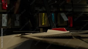 Truck carrying cardboard boxes guided through storage by loader. Factory employee demonstrates how packages loaded with commodities for shipment