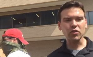 Did an "alt-right" hoaxster plant fake protest signs at a net neutrality protest?