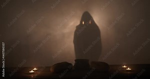 The silhouette of Jesus Christ standing near a table with Christian sacraments of bread and wine for last supper, communion, Easter symbolism. In cinematic slow motion with ambient light. vídeo do Stock