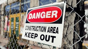A close up view of a danger sign at a city construction site.