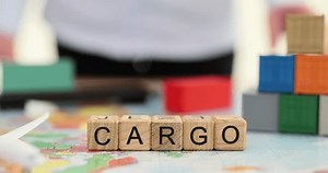 Sales agent places cargo container on world map and word cargo. Global logistics partnership