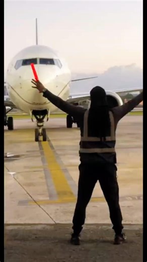 Ground crew is guiding the plane to the parking spot! #airplane #airport #groundcrew