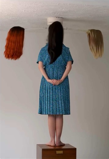 Photographer Brooke DiDonato creates surreal, carefully staged photographs that transform ordinary spaces, familiar objects and the human body into impossible scenes. Her work frequently explores identity, perception and the strange relationship between people and their surroundings. In these images, the human figure becomes almost anonymous. A woman stands beneath a collection of suspended wigs, while another figure appears in a suit with a framed childhood portrait replacing its head. #art #ar