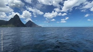 Saint Lucia pitons as seen from the water. The Pitons are two mountainous volcanic plugs, volcanic spires, located in Saint Lucia.