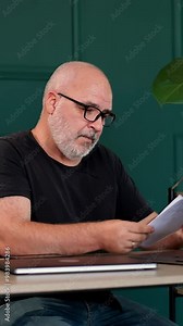 Vertical video. Professional male programmer brainstorming in a modern office. Ideal for themes of innovation, technology development and collaborative problem solving.