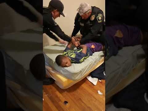 Jabari restrained by police officer