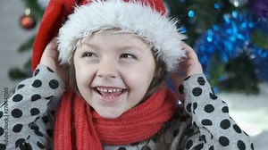 Funny Santa hat. Adorable little girl having fun in a santa hat.