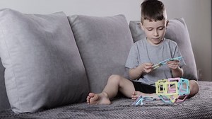 A little boy gaming with magnetic constructor. Creativity development. Magnetic constructor.