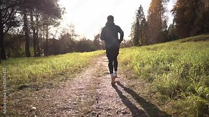 Runs takes steps jogging running in the fall, training a male trainer to warm up his legs by running a long distance. A man in warm sports clothes for winter training. Stock Video