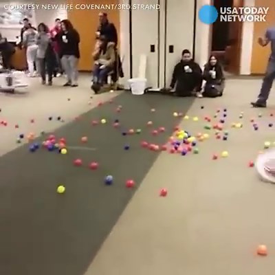 Couples at a marriage retreat play a life-sized version of Hungry, Hungry Hippos using laundry baskets. | USA TODAY Video