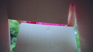 Download girl excitedly opening gift boxes for free