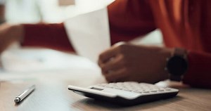 Hands, paperwork and calculator for finance agency as accountant with audit, planning and investing. Person, bookkeeping and corporate taxes for loan, document and payroll in asset management or bank