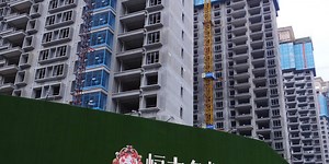 Evergrande pays delayed interest on at least two bonds, looking to avoid default
