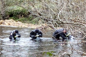 Watch: Underwater search teams sweep river near scene of fatal stabbing