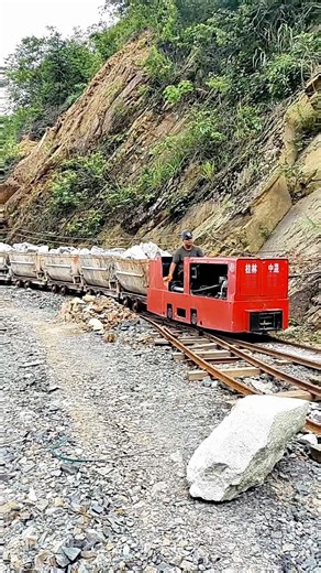 Watch This Mining Train Haul Tons of Rock Through a Narrow Mountain Quarry Track