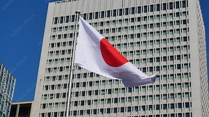 Japan flag with background of modern high-rise building in Tokyo,Japan