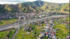 Aerial of the town of Bontoc, the capital of the landlocked province of Mountain Province, in the Cordillera Region of the Philippines. A valley town with terraced rice fields and residential areas.