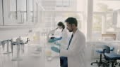 Scientists in lab coats working in laboratory