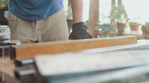 A worker is grinding rust off a steel part with an angle grinder. Close-up.