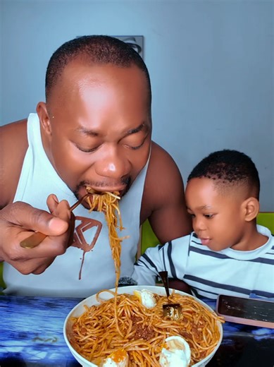 Father and Son Enjoying Delicious Spaghetti Tonight