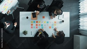 Time lapse of professional businessman explain marketing plan while put sticky note on whiteboard. Top down aerial view of skilled diverse business group discuss or brainstorm strategy. Directorate.