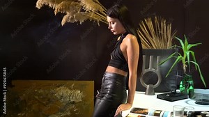 Young beautiful female fashion model smoke the cigarette. pretty woman wears elegant black clothes and reads the book