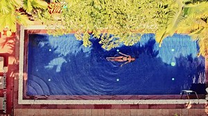 Woman Floating On The Pool During Daytime