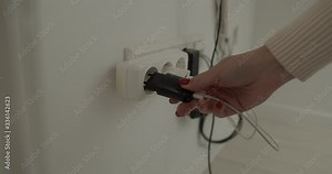 a socket with many things loaded. A girl hand that puts something loaded into the socket.