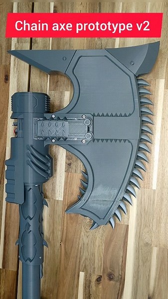 @alex_geek_workshop on Instagram: "Chain axe prototype v2. All mechanics now work well. Next step is add some decorations like skulls and ect. As you asked, I made 2 triggers for the lower and upper grip. this complicated the assembly, but what won't you do for the sake of the fans. next week I plan to complete the design and a physical copy will be available for order. but I will need about 3 more weeks to prepare the instructions, STL, firmware and kits to publish the STL product for sale. . .