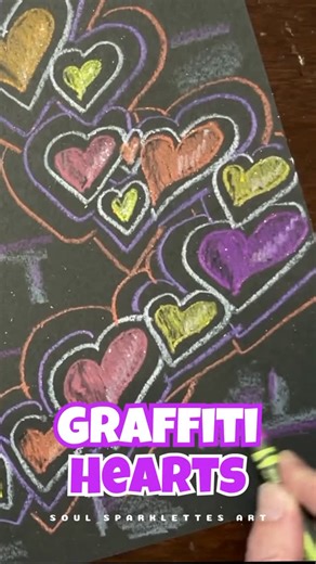 Soul Sparklettes Art | Julie Soul on Instagram: "💘 Graffiti Hearts with Crayons A Valentine’s Day art project that proves simple supplies can still make big impact. These bold, layered graffiti hearts were made using only crayons on black paper—no paint, no water, no mess. The secret? Letting kids build up color, outlines, and movement the way street art does. ✨ Construction paper crayons show up beautifully on black ✨ Regular crayons or oil pastels work too (experimenting is part of the fun!)