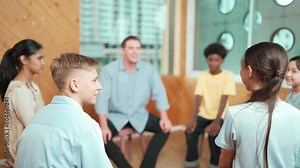 Smart girl raising hand to ask question during doing group therapy. High school student put hand up to ask question, voting, volunteering, asking, answering question between group meeting.Edification