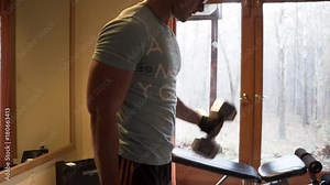 Teen bodybuilder curling heavy dumbbells.