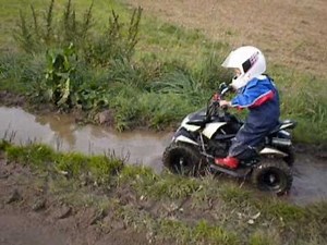 Kid (Till) 3 years with Quad in the mud.