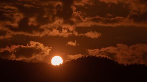 Download Sunrise over a mountain in the orange sky 4k time lapse video. for free