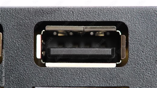 Extreme macro video of an USB Type-A female port socket on black electronic device panel, slow zoom-in on connector interface, computer hardware connection, data transfer technology detail, no people