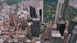 Aerial Orbiting view of Manhattan, New York City, featuring skyscrapers and Central Park, highlighting iconic urban landscapes and architecture in virtual simulation, Computer-generated footage