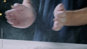 Man clapping with the hands full of flour