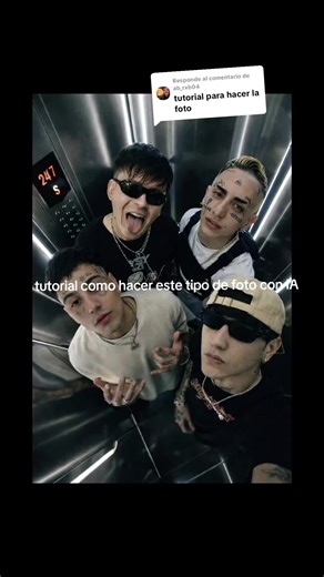 Respuesta a @ab_rxb04 crea una fotografía, la foto tomada desde un ángulo alto, mirando hacia abajo, se aprecian las 4 personas de las fotos recomendadas dentro del ascensor moderno. El ascensor tiene paredes metálicas y brillantes, hay luces verticales de LED brillantes a lo largo de las esquinas y los lados, creando un fuerte contraste de luz y sombra. A la izquierda se ven los botones del ascensor y un indicador de piso que muestra