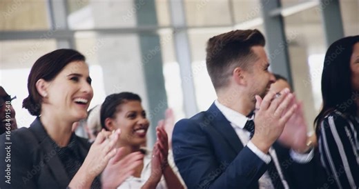 Happy businesspeople clapping their hands in a conference meeting together at what the speaker said. Motivated, excited and diverse group of professionals sitting at a business event writing notes
