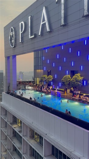 The iconic rooftop infinity pool on the 51st floor provides panoramic views of the Twin Towers