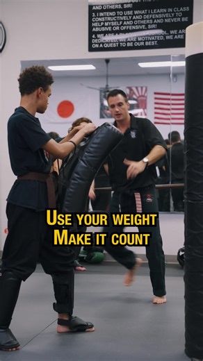 Step Into It! Teaching students how to add power to their kicks by stepping behind the target before delivering the strike. Rather than throwing a kick from a flat stance, the key is to move with purpose. Stepping in and driving through with the shin. This movement creates full-body momentum and teaches students to transfer their weight correctly. Students are coached to deliver three thrusts per leg, three rounds per leg, focusing on shin contact, control, and strong extension. This drill impro