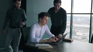 A Male Mentor Providing Oneonone Training to a Trainee on a Laptop in a Corporate