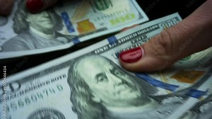 Woman counting american dollars cash money.