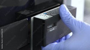 close up of science experiment Vials filling inside an autosampler of an HPLC machine inside view in a Scientific experimental laboratory for research development analysis and clinical trial study