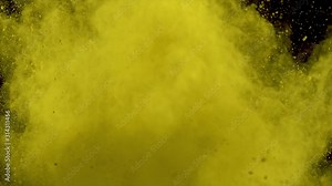 Realistic yellow powder dust explosion on black background. Slow motion movement of dust remains engulfing screen