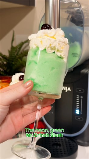 You’re a mean one, Mr. Grinch… until you try this 💚 This frosty green slush is the perfect Christmas party showstopper 🍹 Ingredients: 80ml Green Squash 250ml Sprite 30ml Lemon Juice 1 tsp Simple Syrup 2–3 drops Green Food Colouring Optional for decoration: Squirty cream Cherry Method: 1. Pour the green squash, Sprite, lemon juice, simple syrup, and green food colouring into your Ninja Slushi. 2. Select the Slush function and let the machine work its magic. 3. When the Ninja Slushi beeps, dispe