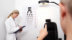 Female optometrist taking eye test of young patient Free Stock Video Footage