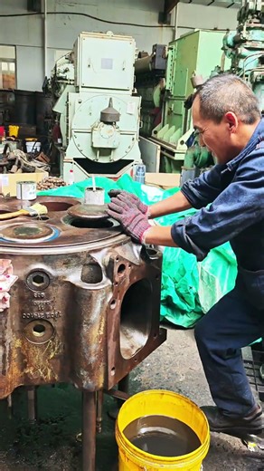 Using His Feet To Grind Valves On A Massive Engine