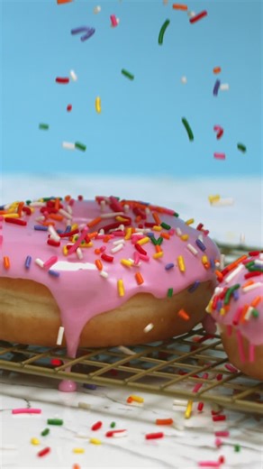 Sprinkles Falling onto Freshly Baked Donuts - Free Stock Video